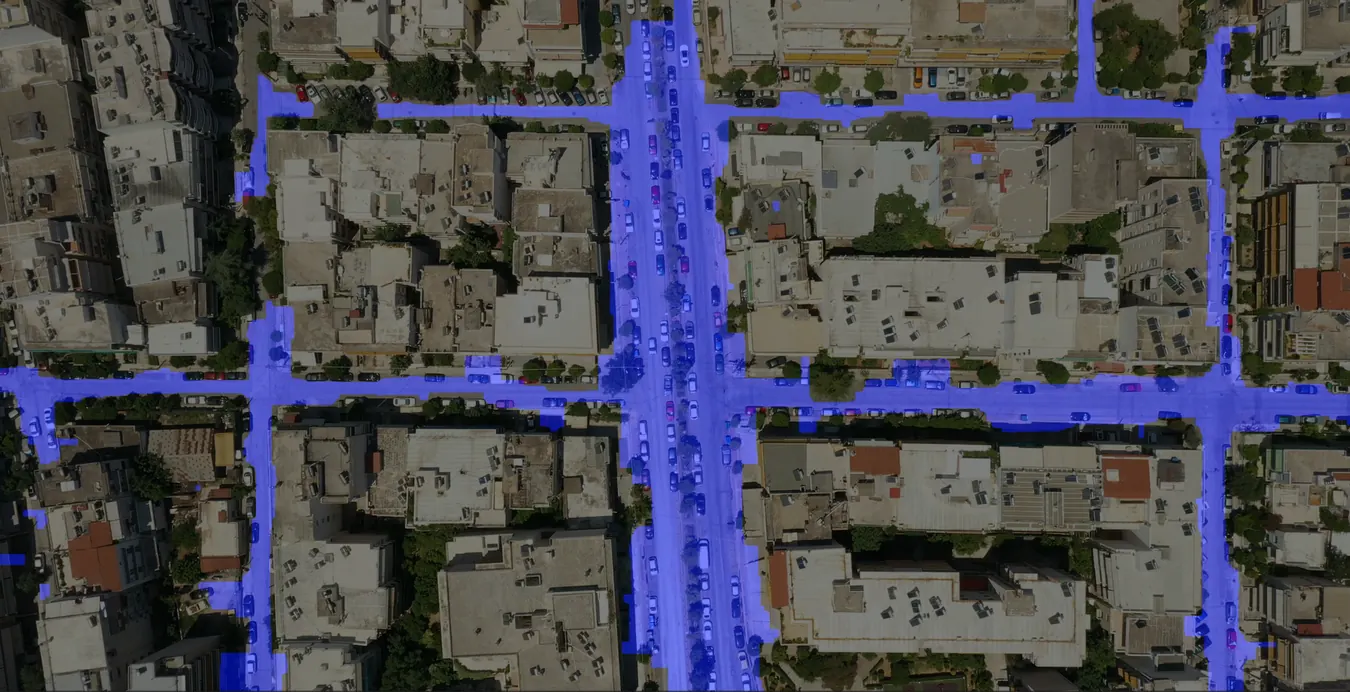 Aerial drone frame of an urban intersection with the road surface segmented in blue