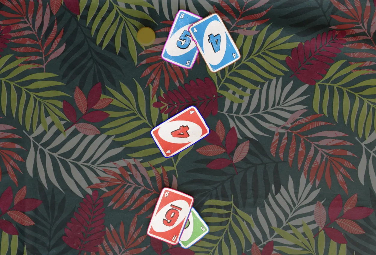 Playing cards spread across a leaf-patterned cloth, each outlined by the segmentation stage